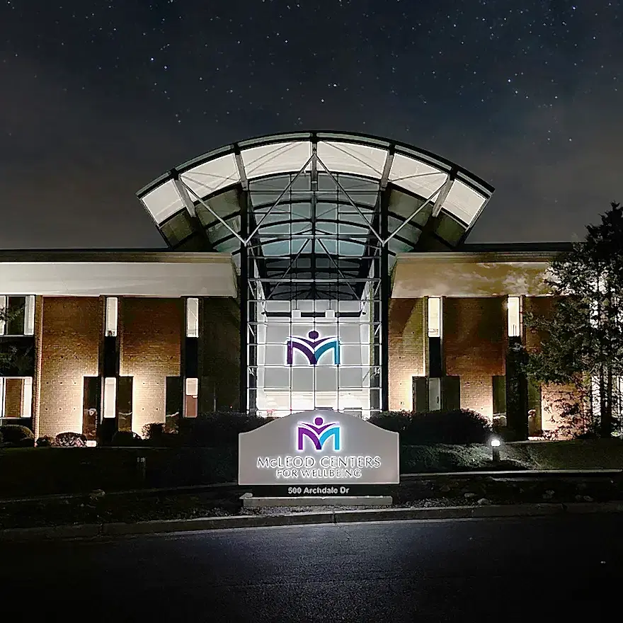 Nighttime view of signage at McLeod Monument